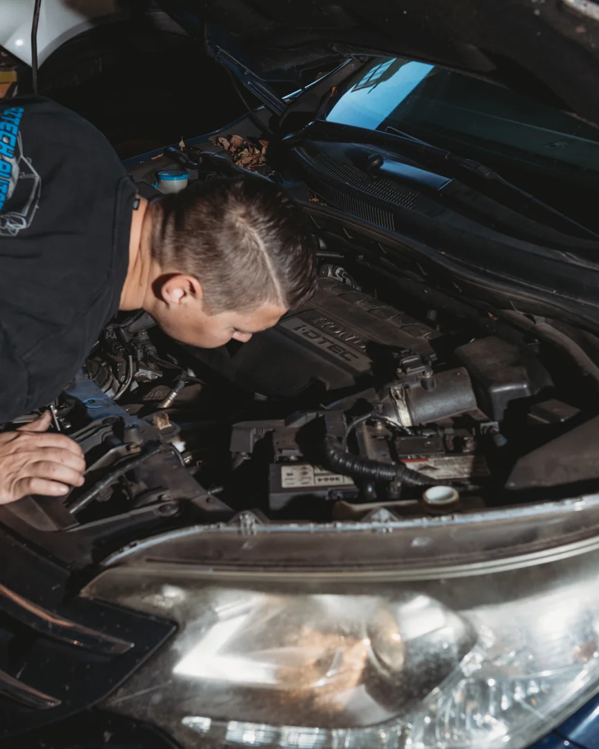 Aztech mechanic inspecting a vehicle in the Brendale workshop