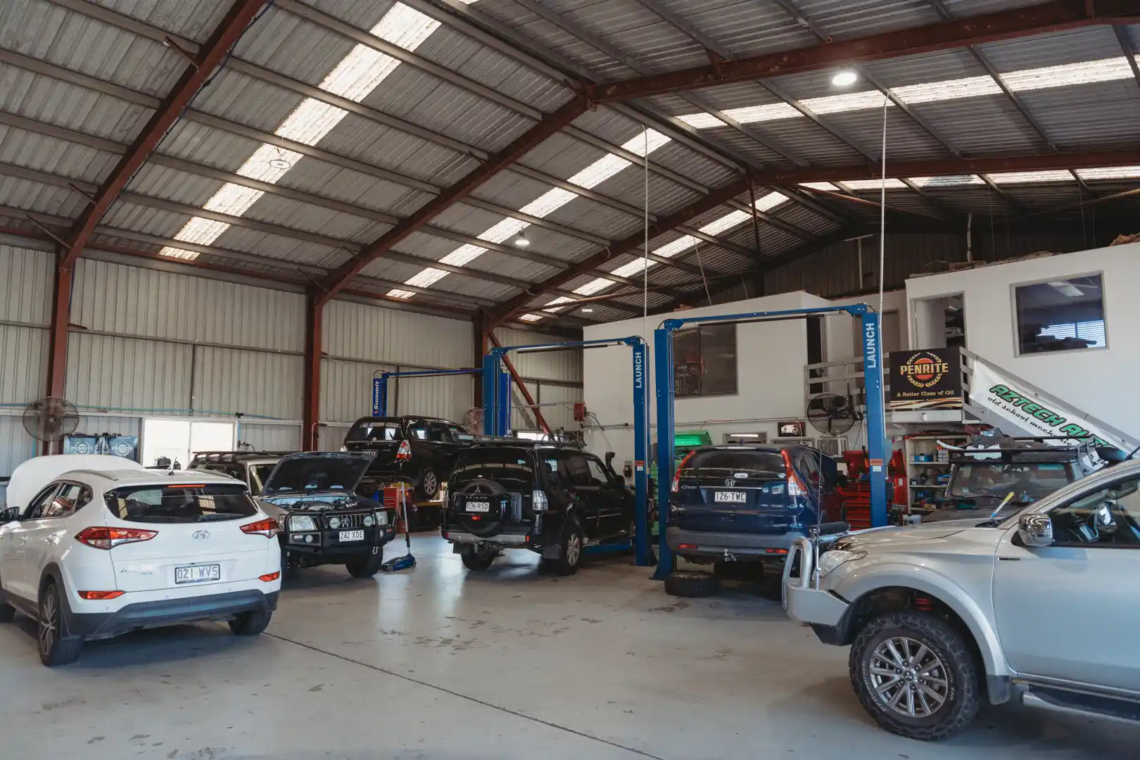 Vehicles inside the Aztech Automotive workshop in Brendale