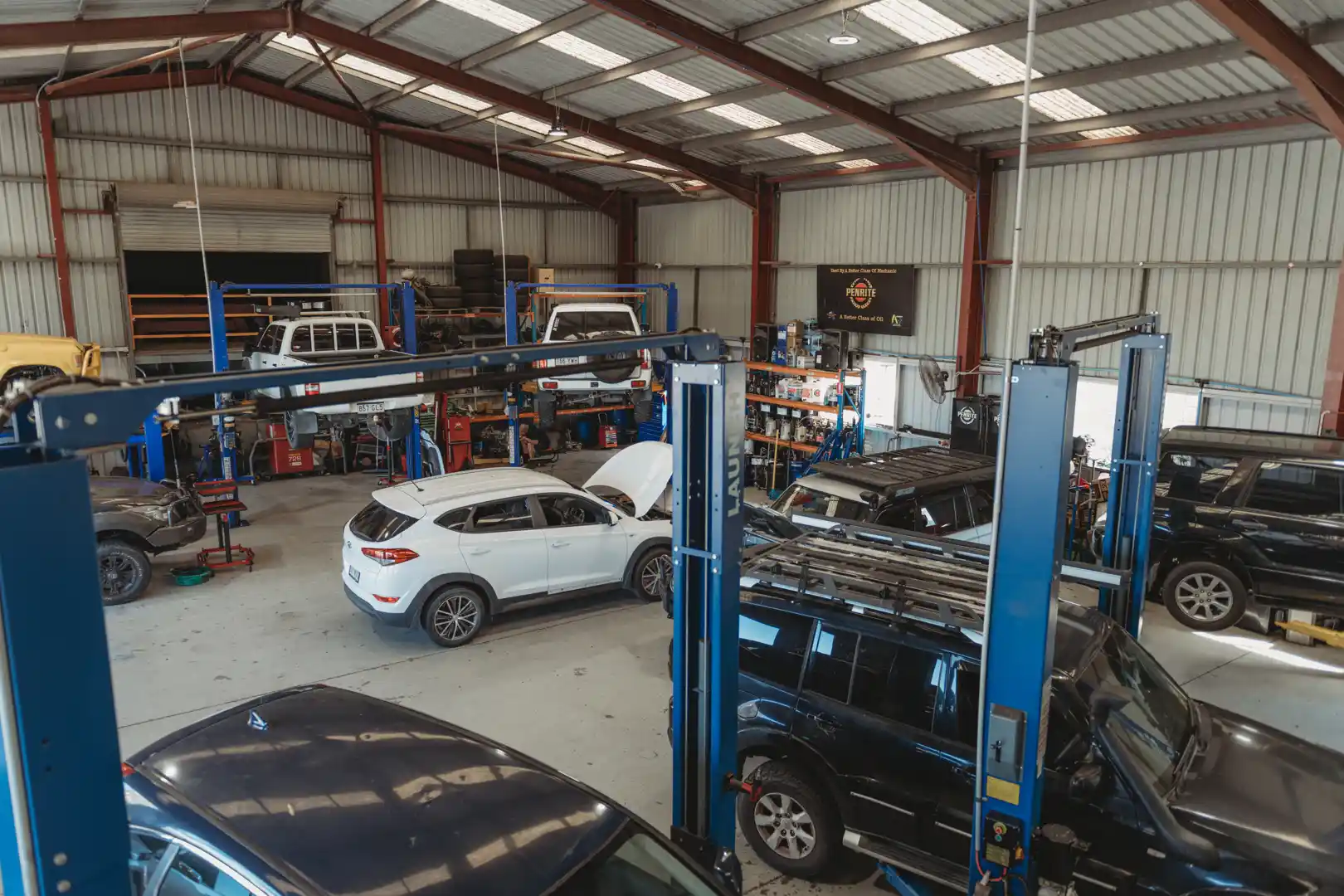 Interior of the Aztech Automotive workshop with vehicles on hoists